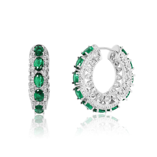 Pair of hoop earrings with green gemstones on a white background