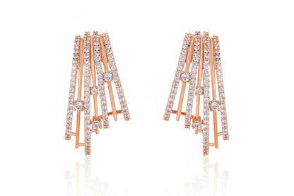 Gold and diamond earrings on a white background
