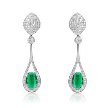 Pair of earrings with green gemstones and diamond-like stones on a white background