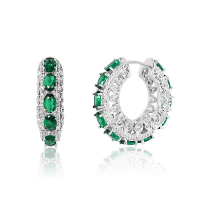 Pair of hoop earrings with green gemstones on a white background