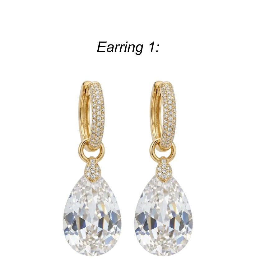 Gold teardrop earrings with clear gemstones on a white background
