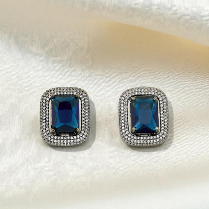 Pair of blue gemstone earrings with silver accents on a white background