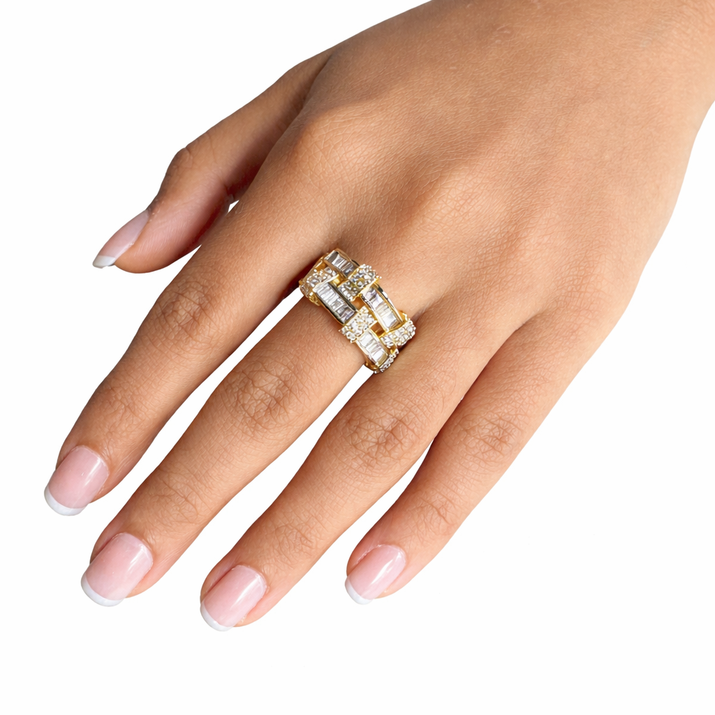 Hand wearing a gold ring with diamonds on a white background