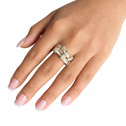 Hand wearing a gold ring with diamonds on a white background