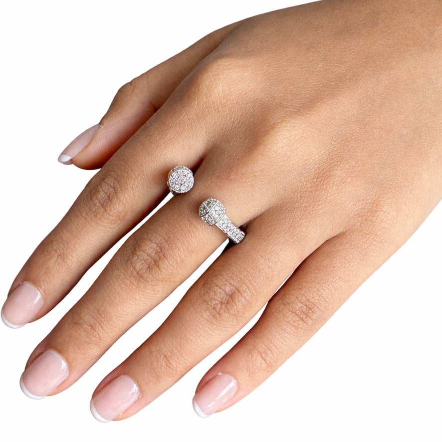 Hand wearing two diamond rings on a white background