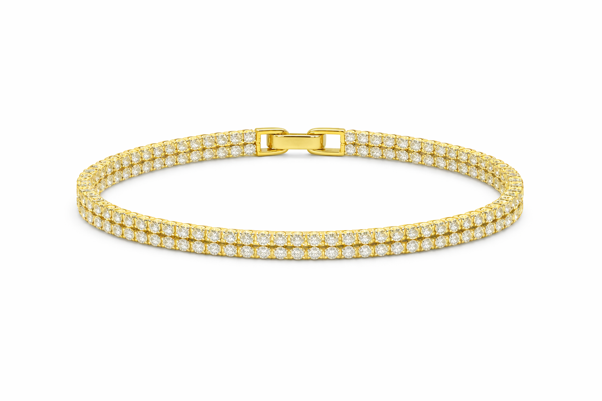 Gold bracelet with diamond accents on a white background