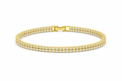 Gold bracelet with diamond accents on a white background