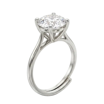 Diamond ring on a reflective surface with a white background