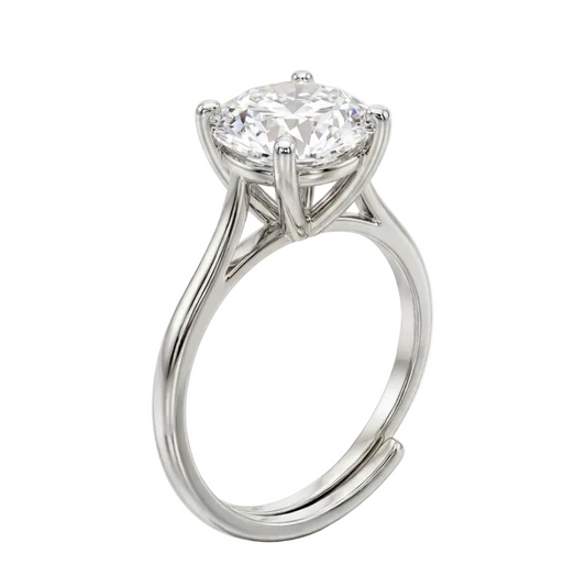 Diamond ring on a reflective surface with a white background