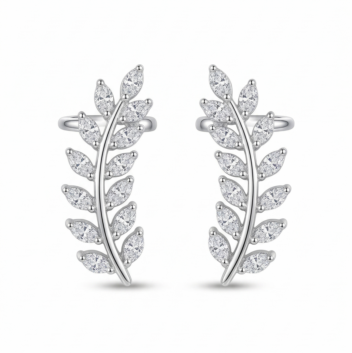 Pair of silver leaf-shaped earrings on a white background