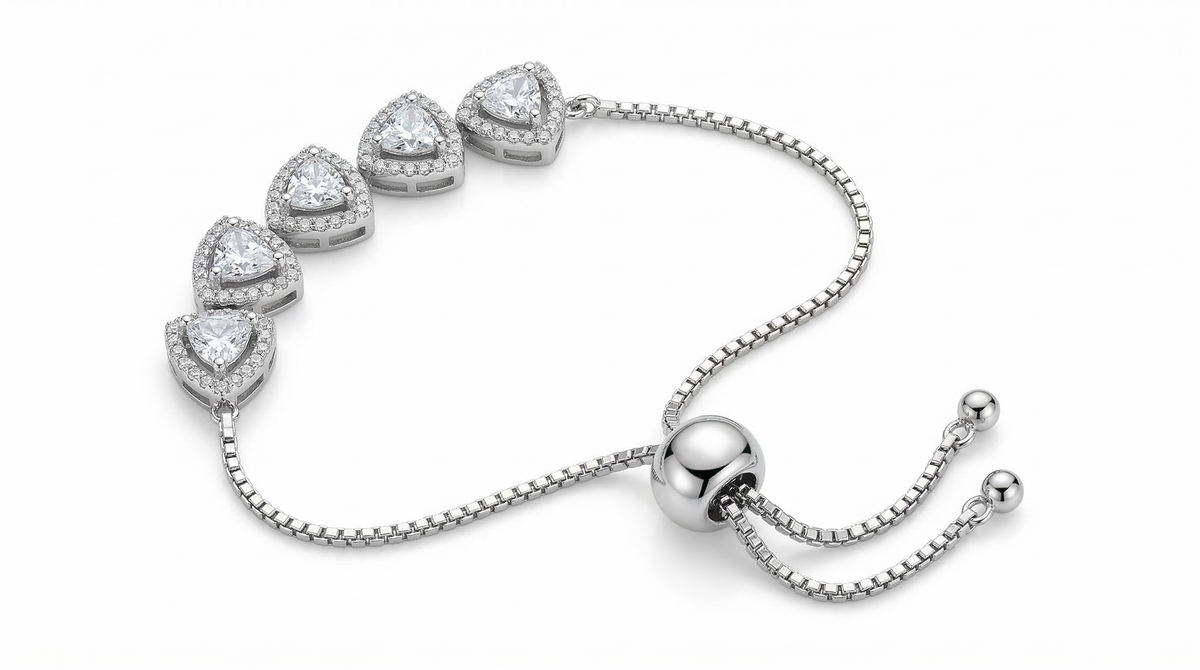 Silver bracelet with heart-shaped diamond charms on a white background