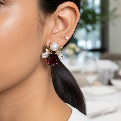 Close-up of a woman wearing earrings with a blurred restaurant setting in the background