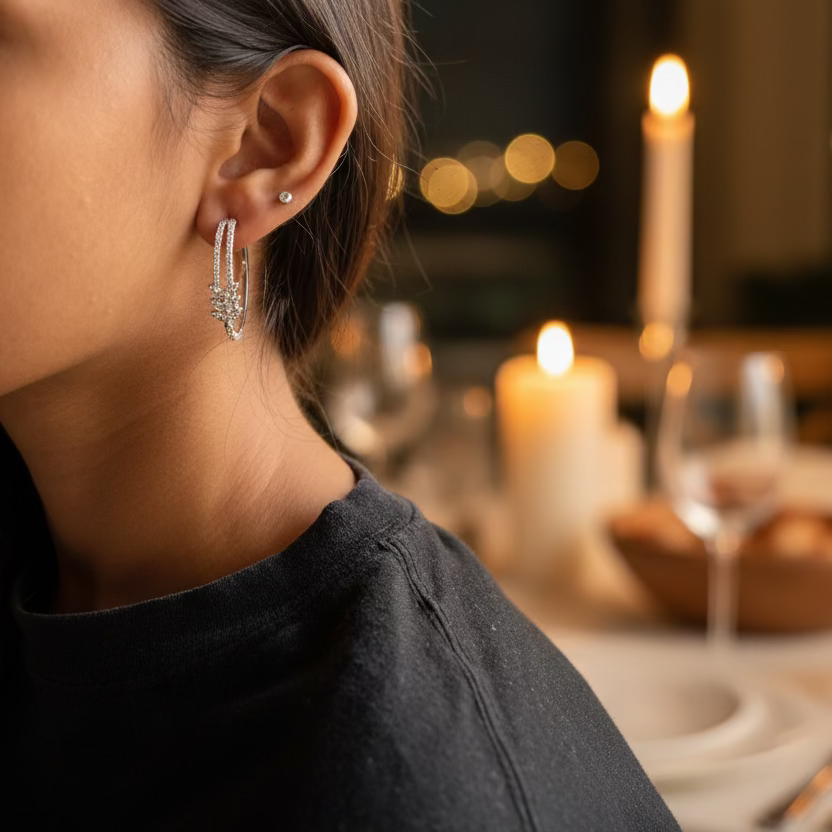 Close-up of a person wearing hoop earrings with a blurred background